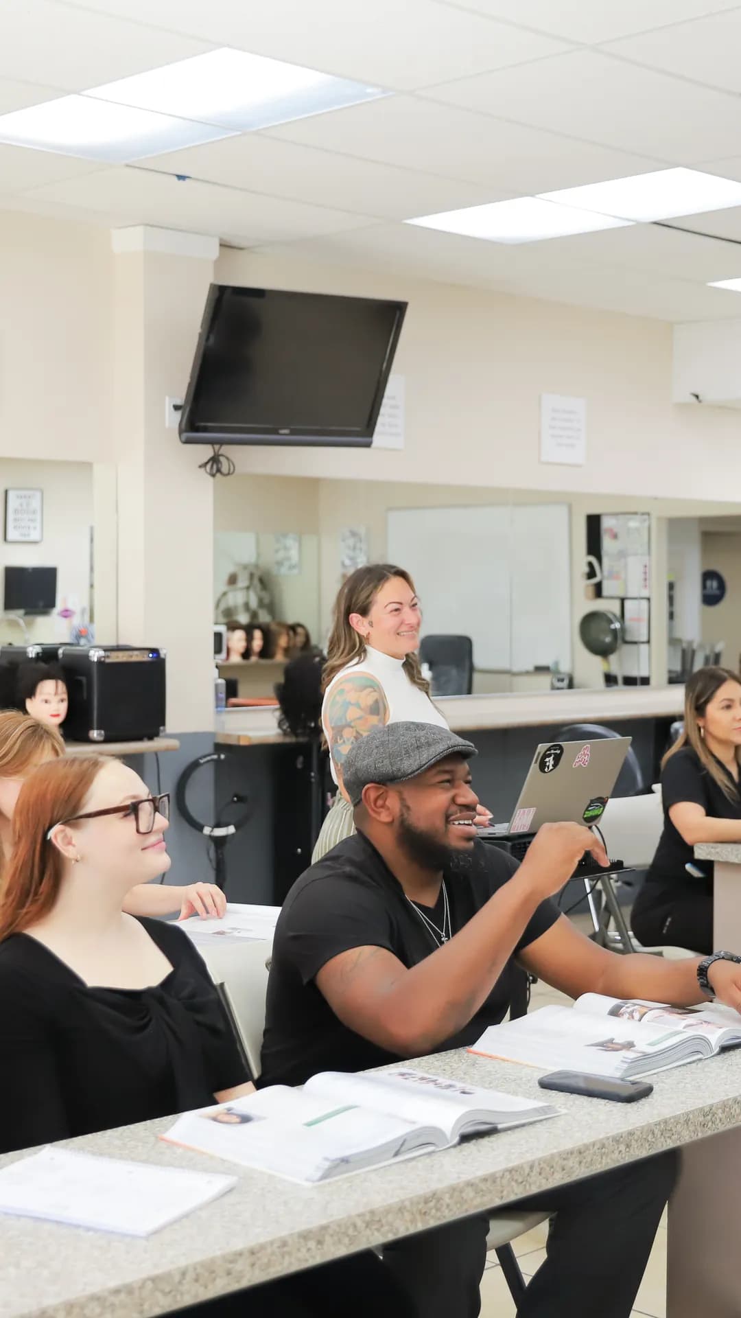 Young instructor in beauty academy classroom