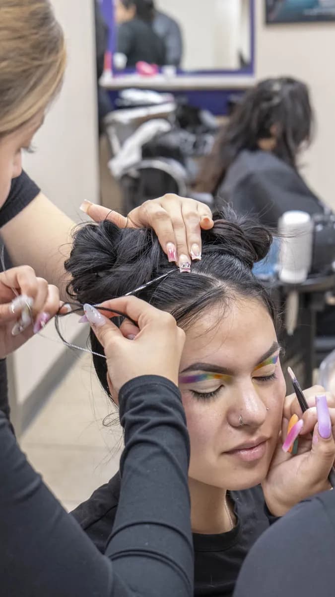 Young makeup artist creating dramatic eye look