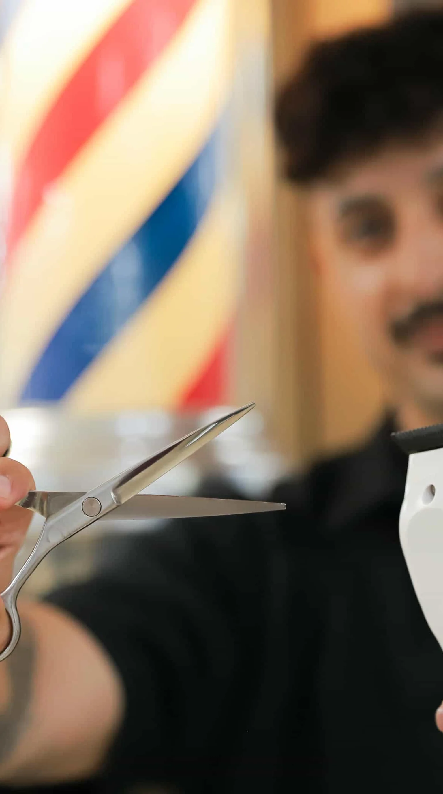 Barber working on client in classic barbershop