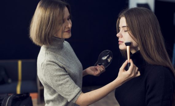 side-view-makeup-artist-applying-powder-model